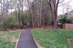 Turn right on to the asphalt trail leading away from Wards Grove Cir and follow the trail into the woods.