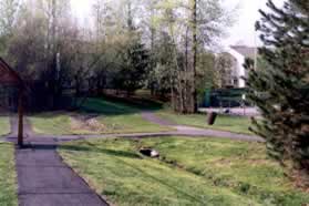 The trail passes the tennis courts and turns left on the other side.  Turn right onto the intersecting trail and right again to pass on the right side of the pool.