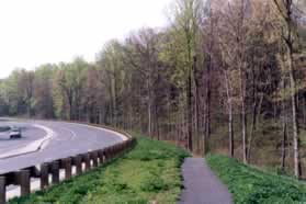 On the other side of Roberts Pwy turn left to follow the asphalt trail along that road.