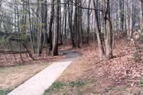 The sidewalk ends.  Take the asphalt trail up the steep hill.