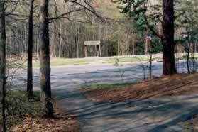 The path leads to Burke Center Pwy. Cross over to the trail on the other side.