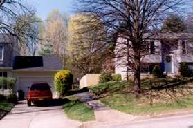 Take the asphalt path between the homes across the street.