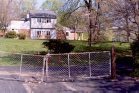 Walk through the gap in the fence next to the gate. The building shown houses the offices of the  Burke Centre Conservancy grounds.