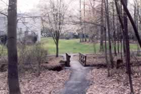 Turn right to cross a bridge over the stream.