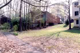 The path turns right and goes between the houses.