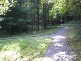 An asphalt trail intersects from the left.  Turn left to follow that trail.