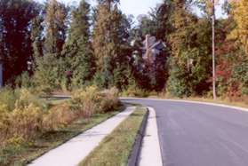 Turn left and follow the sidewalk along Water Pointe Ln next to the pond.