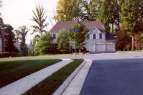 Turn left and follow the sidewalk along Round Pebble Ln.