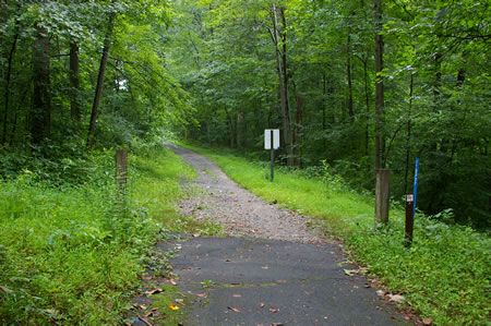 The trail surface changes to gravel as it crosses a water main.