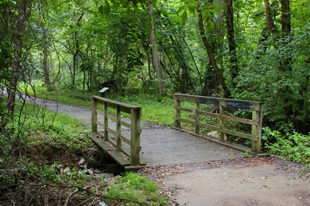 The trail crosses a stream on a bridge.