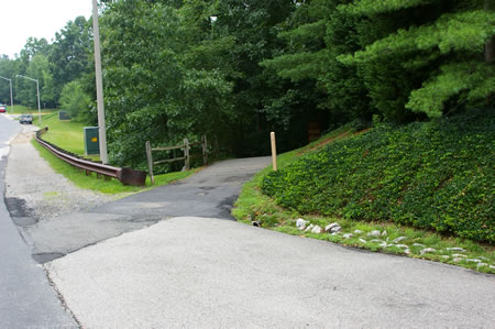 Stay to the right along the paved shoulder of Hunter Village Dr. Turn right onto the asphalt trail at the end of the paved shoulder.