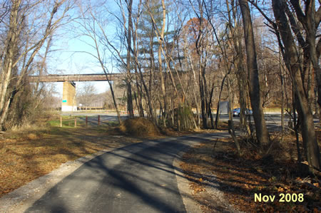 The trail turns right to leave the creek and enter the parking lot.