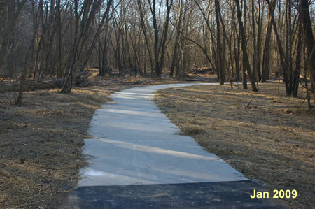 The trail curves to the right to cross the creek.