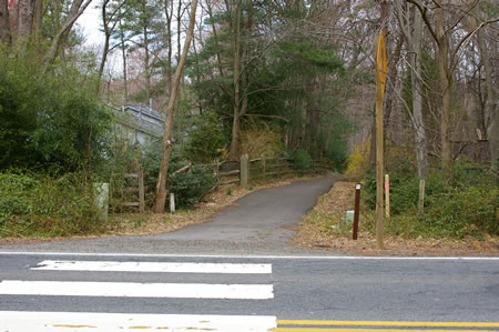 Cross Lawyers Rd at the crosswalk and continue on the asphalt trail on the other side.