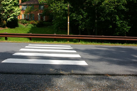 Cross Miller Heights Rd. in the crosswalk.