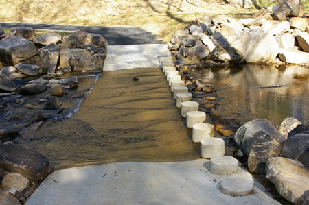 The trail crosses South Run on columns.