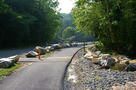 The trail passes an access road and a parking area for Camelot Pool, a private club. This marks the end of this section of the walk. Continue on the trail if you wish to walk the next section.