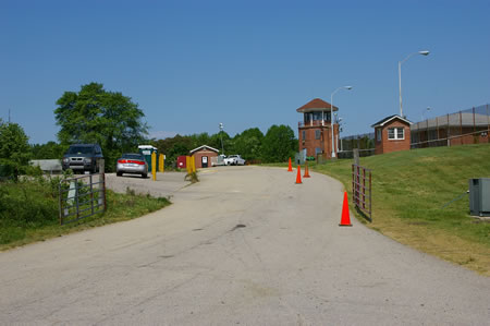 Continue past an entrance road and a parking area on the left.