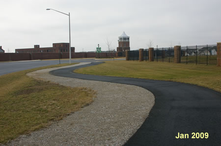 Take the asphalt trail on the northwest corner of White Spruce Way and follow it towards the fenced community.