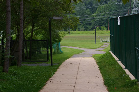 Follow the trail with the skateboard ramps on your right.