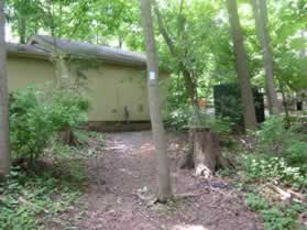 The trail passes a storage building.  Continue straight on the trail past the building.