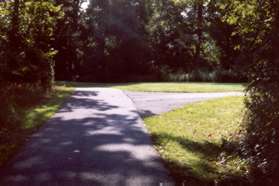 Go straight at the next trail intersection.  A tennis court will appear on your left.