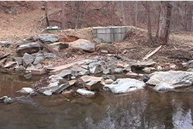 Stream water is diverted into a pipe here to feed the pond at the mill.