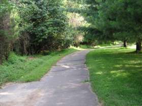 The Cross County trail from the Dulles Highways intersects from the left.  Continue straight on the present trail behind the homes.