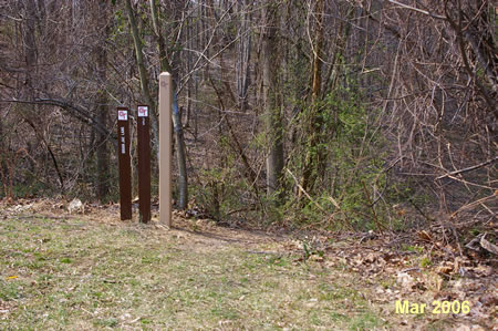 The trail emerges at a driveway. Rejoin the trail on the other side of the circle at the end of the street.