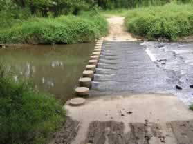 The trail crosses Difficult Run on columns.