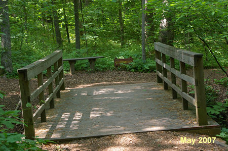 The trail crosses a bridge. Turn left at the trail intersection on the other side.