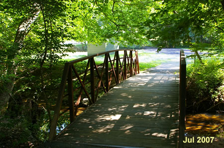 Follow the gravel access road on the other side of this bridge to the street.