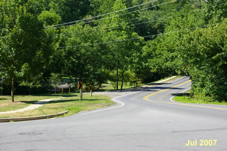 Cross Fairway Dr. and continue on the sidewalk along Creek Crossing Rd.