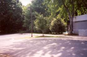 The sidewalk passes a day care center on the right.