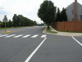 Turn right to follow the sidewalk along Hunter Gate Wy.