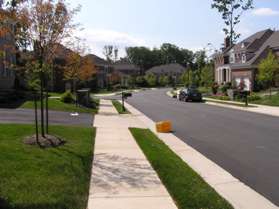 Turn left to follow the sidewalk along the left side of Cameron Heath Drive.