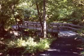 The path crosses one of the few pedestrian bridges over Sugarland Run.