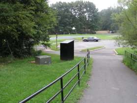 The trail reaches a small parking area.  Turn left to follow the trail around the parking lot.