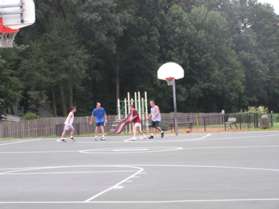 The trail passes a basketball court on the left.