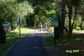 Take the asphalt trail down the hill.  It will curve to the right  to go down the hill on a ramp.