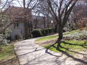 Turn left at the next asphalt trail intersection and follow the trail along the houses on the left.