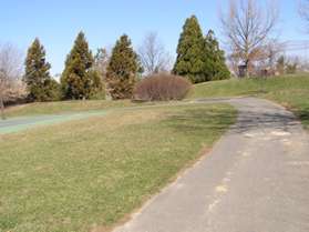 A trail intersects from the Lake Newport dam on the left.  Continue straight on the present trail.