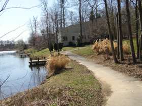 The trail goes down a hill and passes by the lake again.