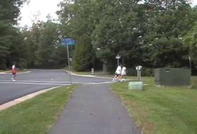 The trail intersects with Lake Newport Rd again.  The walkers shown are part of the Reston Runners group walking a different trail.