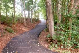 The trail crosses the street and turns right to follow South Lakes Dr.