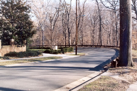 Rock Creek Dr turns sharply to the left.  Continue on the sidewalk.