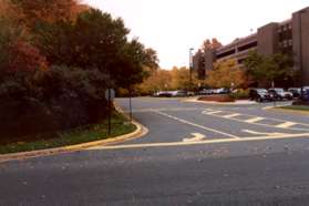 After crossing the entrance to the building on the right cross Follin Lane and follow the asphalt path on the opposite side for only a few feet to driveway crosswalk.