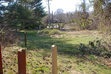 After crossing Leigh Mill Rd . the trail turns to the left to begin the next section.