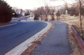 A trail appears curving to the right.  Stay on the trail along Walnut Branch Ln