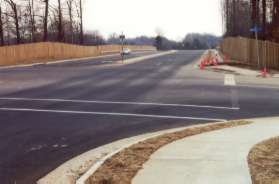 Wiehle Ave intersects with Shaker Woods Rd.  Cross Shaker Woods Rd and continue along Wiehle Ave on the asphalt trail.  The picture is taken from the sidewalk side of Wiehle Ave.